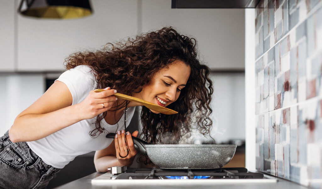 woman-cooker-making-pasta-kitchen
